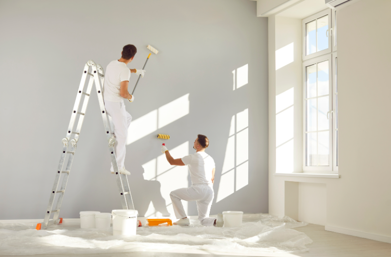 Painters finishing a bright new interior after construction